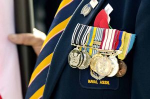 The wearer appears to be associated with a naval association, indicated by the badge on the lapel.