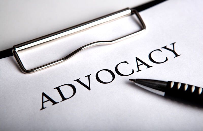 Document with the title of advocacy and pen close up