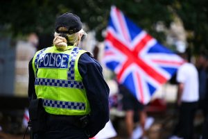 BOURNEMOUTH, ENGLAND - AUGUST 09: Police stand outside The Roundhouse hotel during a demonstration, on August 09, 2025 in Bournemouth, England. Protesters and counter-protesters have gathered outside hotels being used to house asylum seekers in recent weeks, as tensions flare over the government's policies on illegal migration, which has reached record numbers this summer. Some far-right politicians and campaigners have faced allegations of fanning the flames by spreading misleading data on crimes committed by foreign nationals, following isolated reports of migrant arrests in connection to sexual assault charges. (Photo by Finnbarr Webster/Getty Images)
