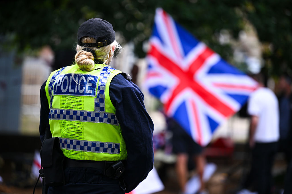 BOURNEMOUTH, ENGLAND - AUGUST 09: Police stand outside The Roundhouse hotel during a demonstration, on August 09, 2025 in Bournemouth, England. Protesters and counter-protesters have gathered outside hotels being used to house asylum seekers in recent weeks, as tensions flare over the government's policies on illegal migration, which has reached record numbers this summer. Some far-right politicians and campaigners have faced allegations of fanning the flames by spreading misleading data on crimes committed by foreign nationals, following isolated reports of migrant arrests in connection to sexual assault charges. (Photo by Finnbarr Webster/Getty Images)