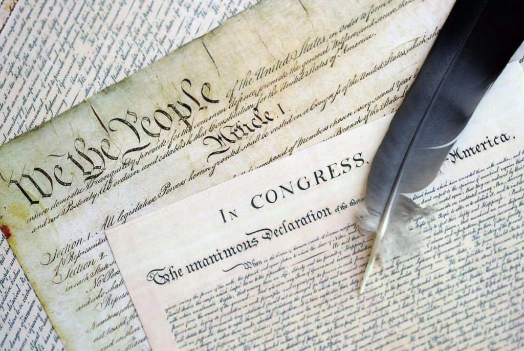 US Constitution with Declaration Of Independence and Quill Pen close up. Patriotism, Fourth of July background