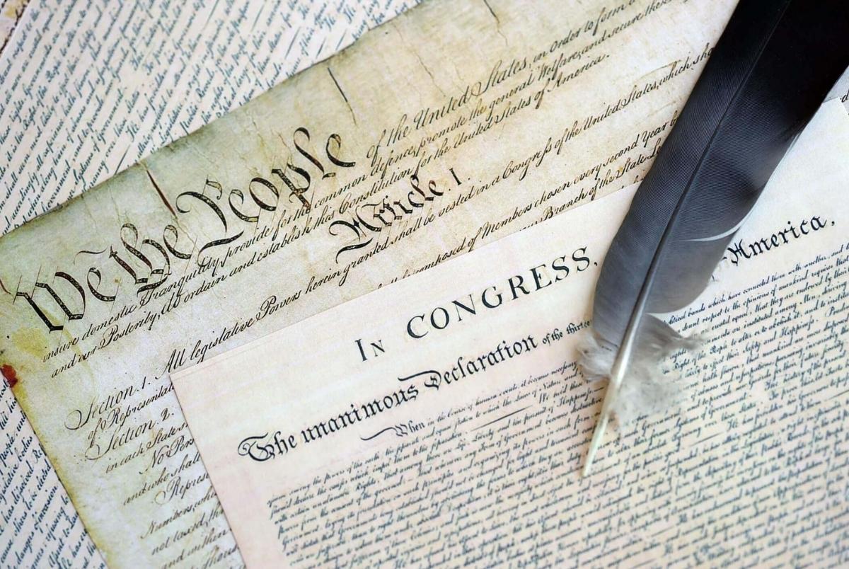 US Constitution with Declaration Of Independence and Quill Pen close up. Patriotism, Fourth of July background