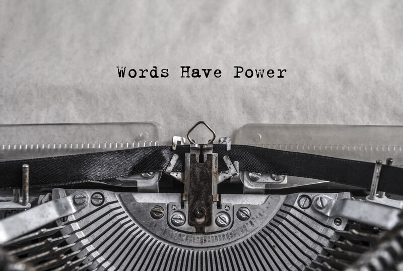 Words have power typed on old vintage aged typewriter with white blank sheet of paper.