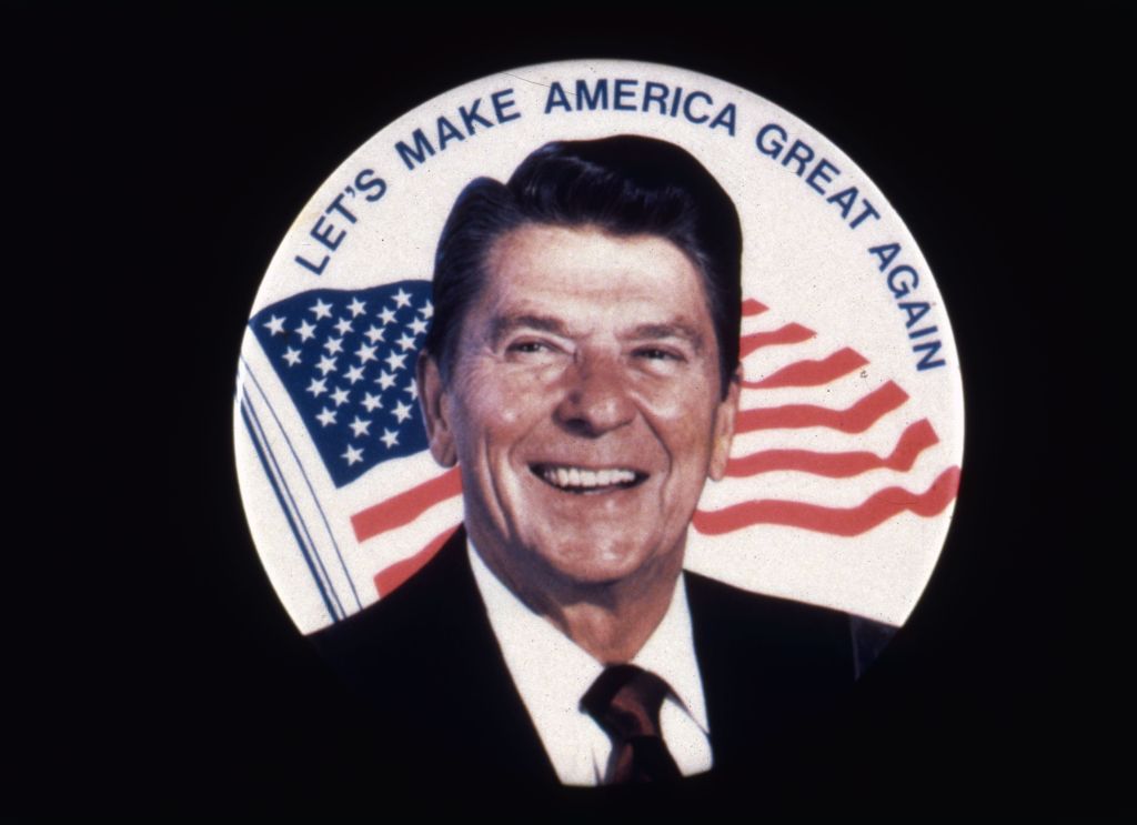 Ronald Wilson Reagan, the 40th president of the United States. A former actor and president of the Screen Actors Guild, he was elected governor of California in 1966 and US president in 1981. He is standing in front of a sign reading 'Let's Make America Great Again', during his electoral campaign.