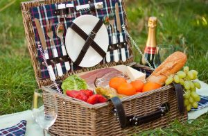 The Picnic Time Newbury Basket features a classic handwoven willow construction with a flat lid design.