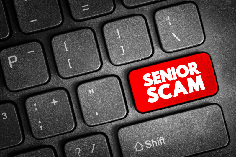 Senior Scam text button on keyboard, concept background.