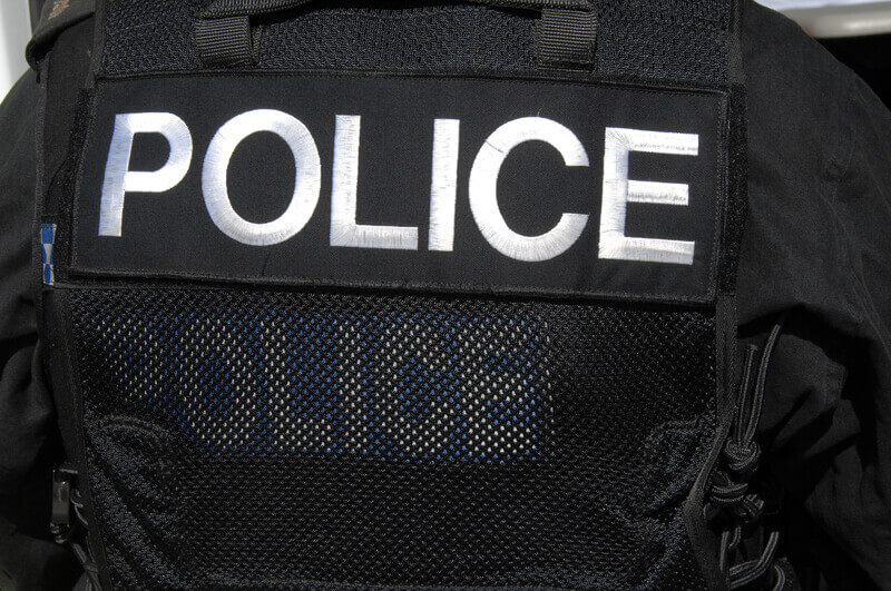 POLICE officer logo on SWAT officers vest. A large POLICE logon on the rear of a SWAT officers tactical vest.
