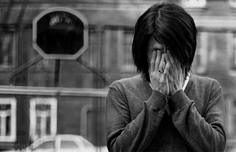 Asian man covered eyes, black and white photo