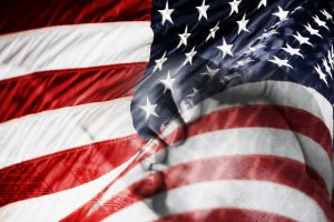 American Flag & Praying Hands (Blended Image). Blended image of an American Flag and praying hands over a Bible - represents faith and prayer for country, military, freedom, peace, and security.