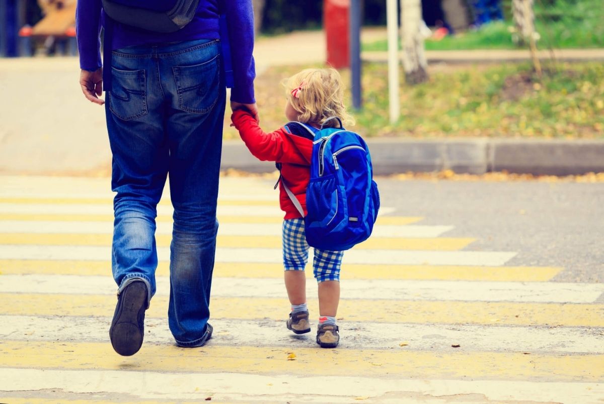 Father with little daughter walking to school or. Father walking little daughter with backpack to school or daycare