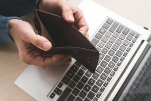 Internet scam fraud online empty wallet lost money. Internet scam. Fraud danger online. Man holding an empty wallet because he lost his money to a fraudster