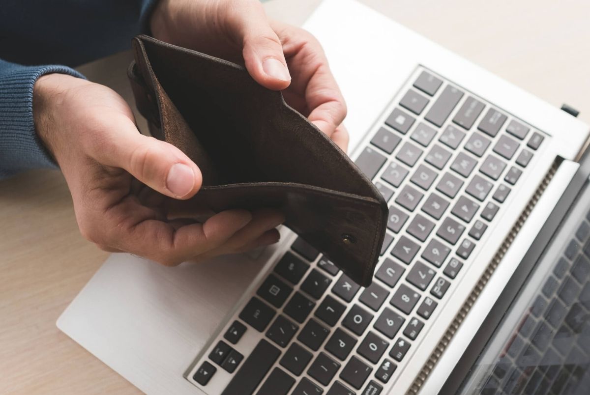 Internet scam fraud online empty wallet lost money. Internet scam. Fraud danger online. Man holding an empty wallet because he lost his money to a fraudster