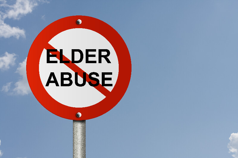 An American road sign and no symbol and word Elder Abuse with sky background and copy space for your message, Stop Elder Abuse Sign