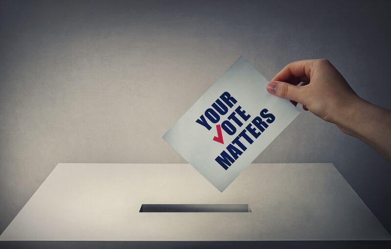 Person at the polling station holding a ballot paper in his hand with the message your vote matters. People legal and democratic rights, every voice counts. Election campaign and electoral agitation
