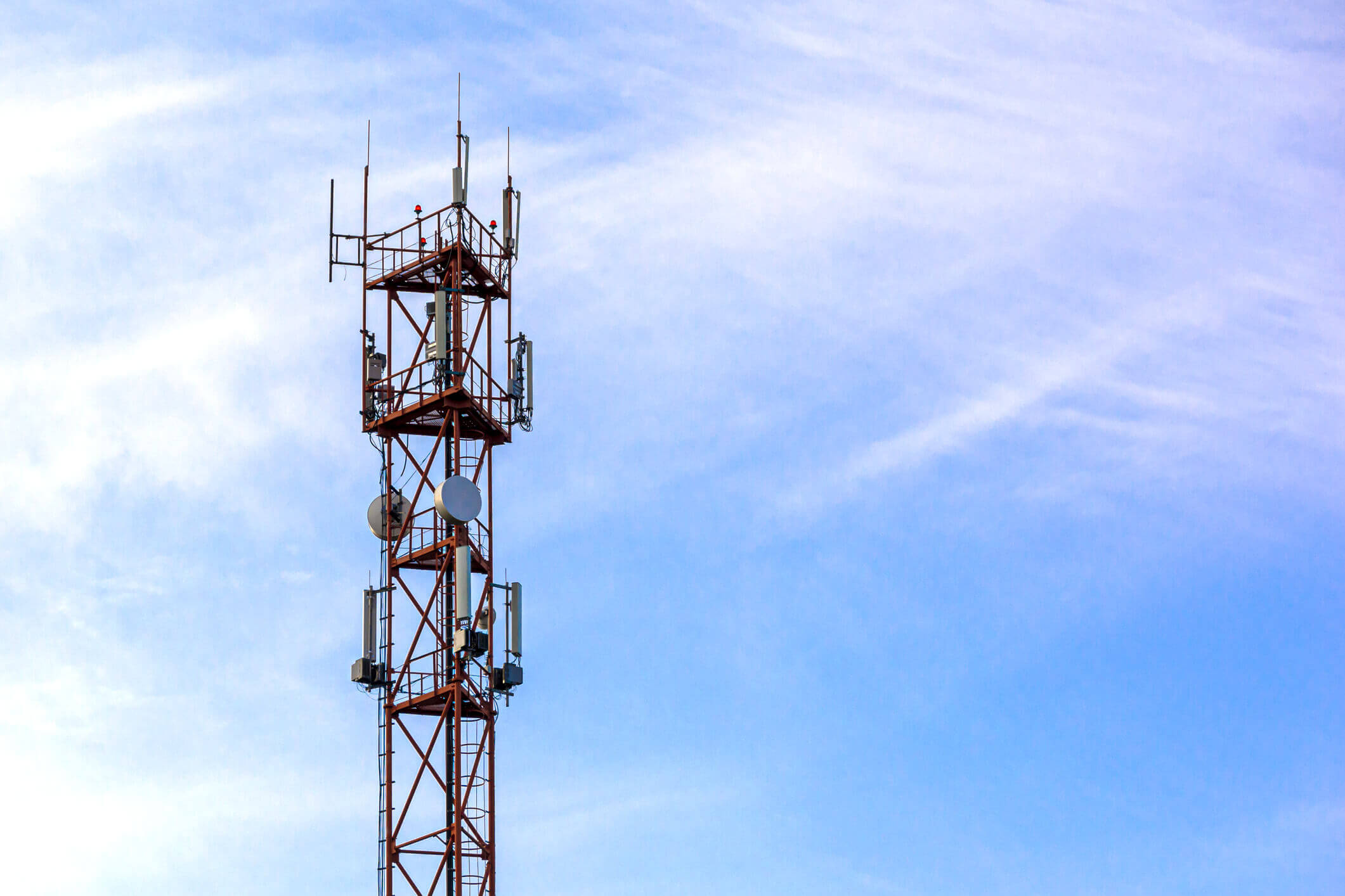 Telecommunication tower against the blue sky with clouds. LTE, GSM, 2G, 3G, 4G, 5G cell tower. Telecommunication tower against the sky. Copy space.