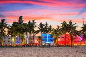 The vibrant neon-lit Art Deco buildings along Ocean Drive in South Beach, Miami.