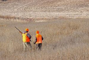 Two Boys Hunting. An older boy is giving advice to his excited younger brother on his first day of hunting.